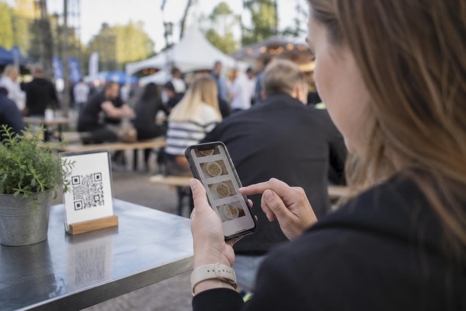 A customer orders food on their phone from a QR code.